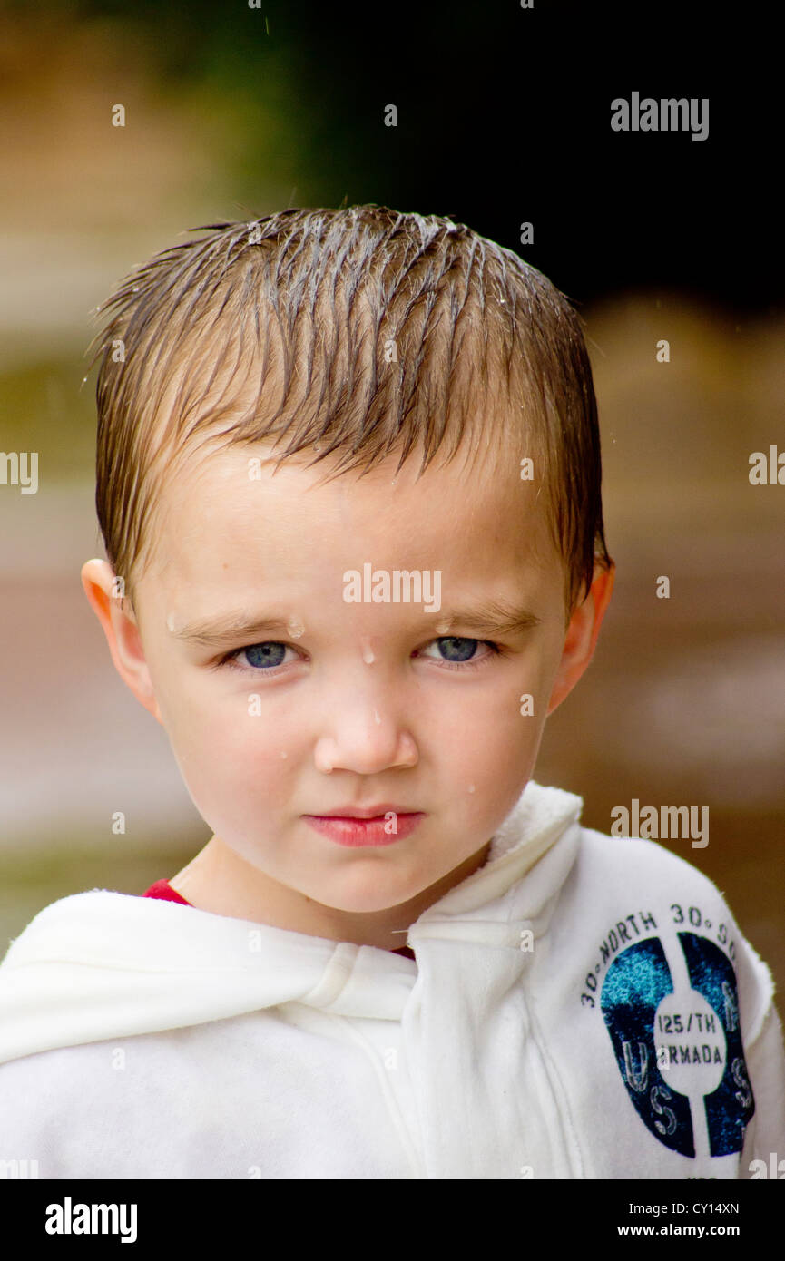 A fiveyearold autistic boy appears from being wet by the rain Stock Photo Alamy