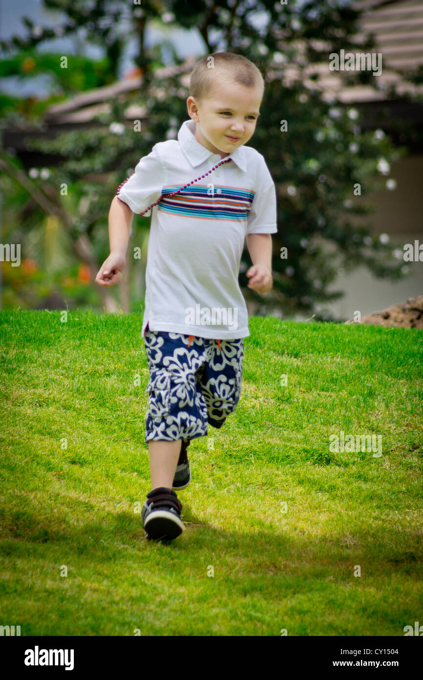 A fiveyearold autistic boy runs with a rock in hand; is he just