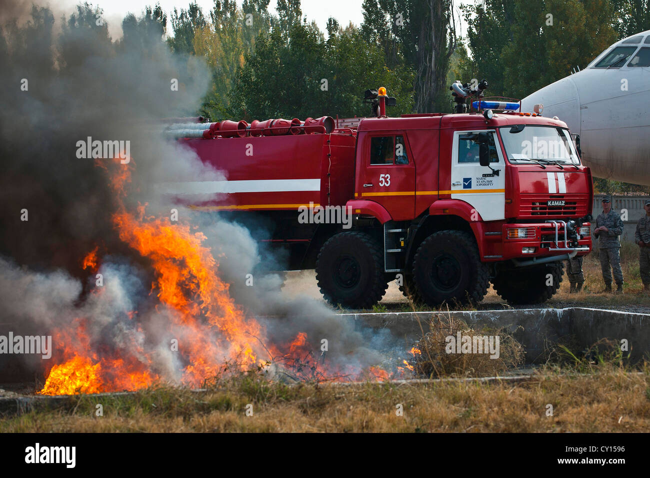 A Manas International Airport firetruck conducts a simulated response to a controlled fire during a demonstration at the Transit Center at Manas, Kyrgyzstan, Oct. 16, 2012. Firefighters of MIA provided a capabilities demonstration to 376th Expeditionary Civil Engineer Squadron firefighters assigned to the Transit Center. Stock Photo