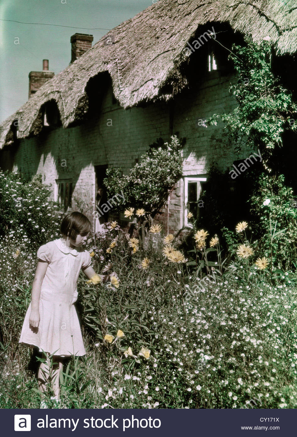 Thatched Cottage Girl Stock Photos & Thatched Cottage Girl Stock Images
