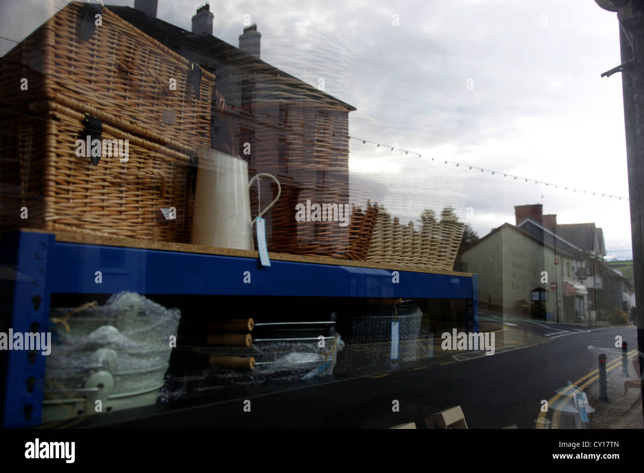 High Street, Llandysul, Wales, Uk reflected in shop window selling baskets Stock Photo