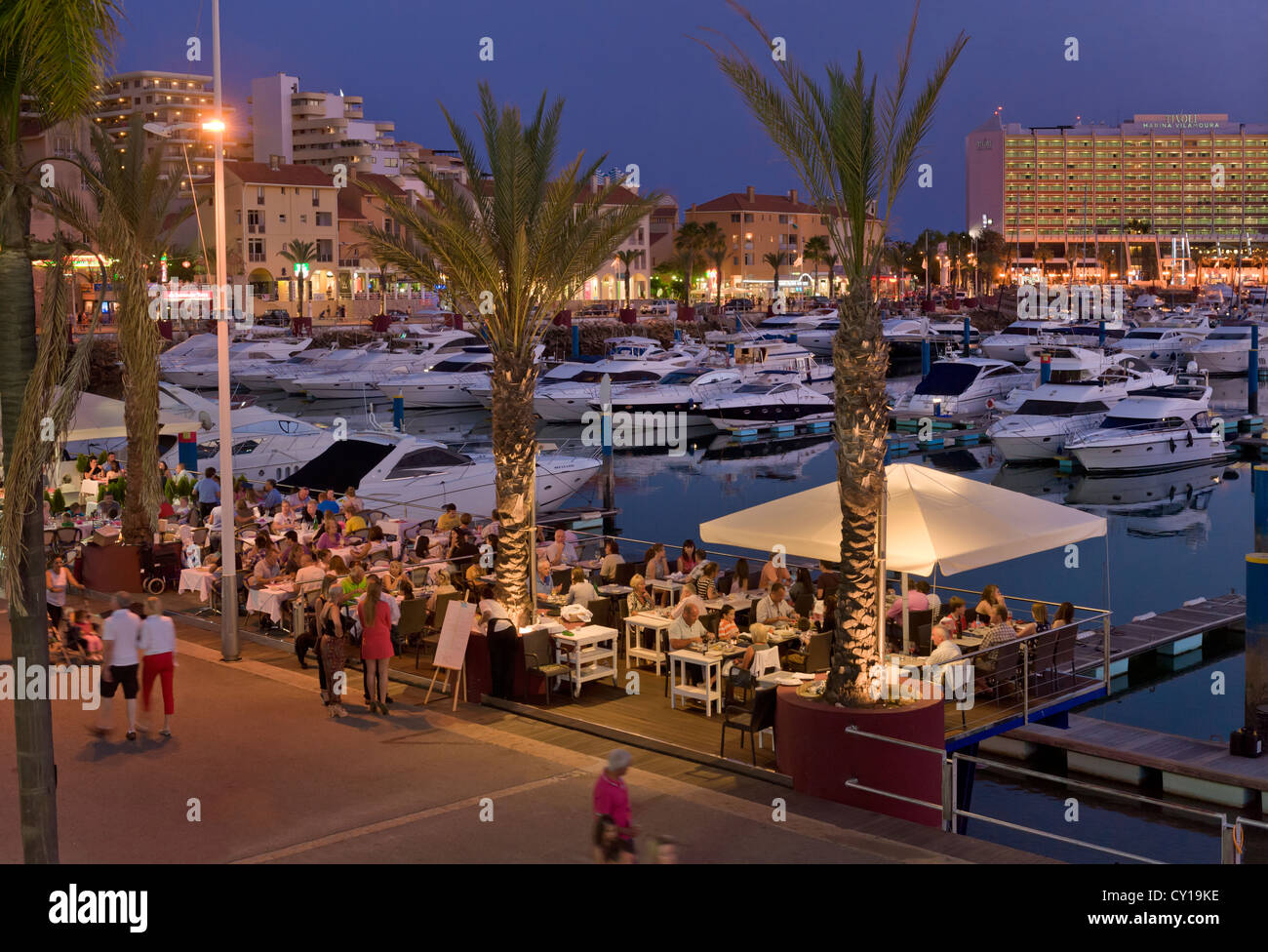 Portugal, the Algarve, Vilamoura marina restaurant on the promenade at dusk Stock Photo