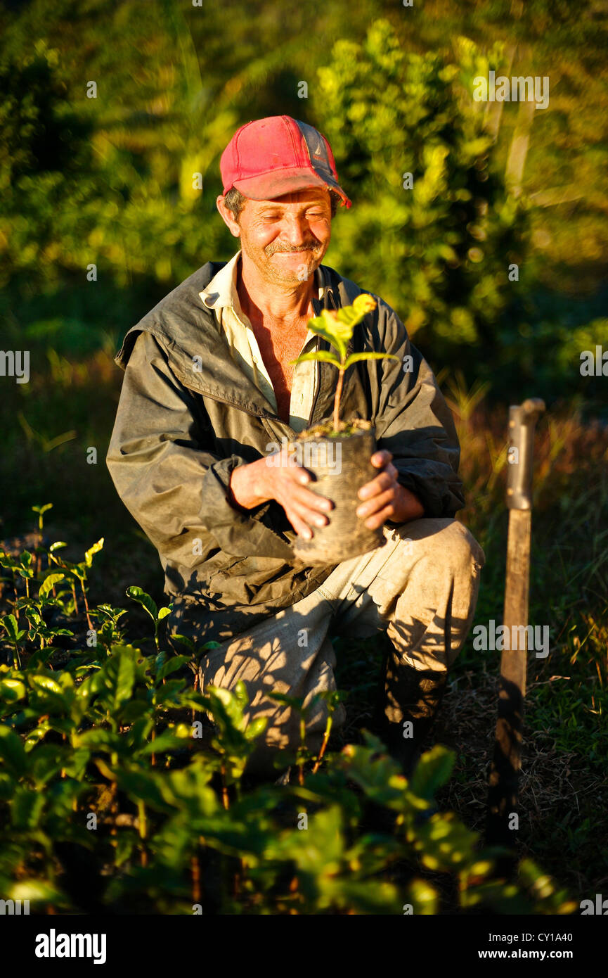 A farmer brightens with a smile showing he's pleased with his work. Stock Photo