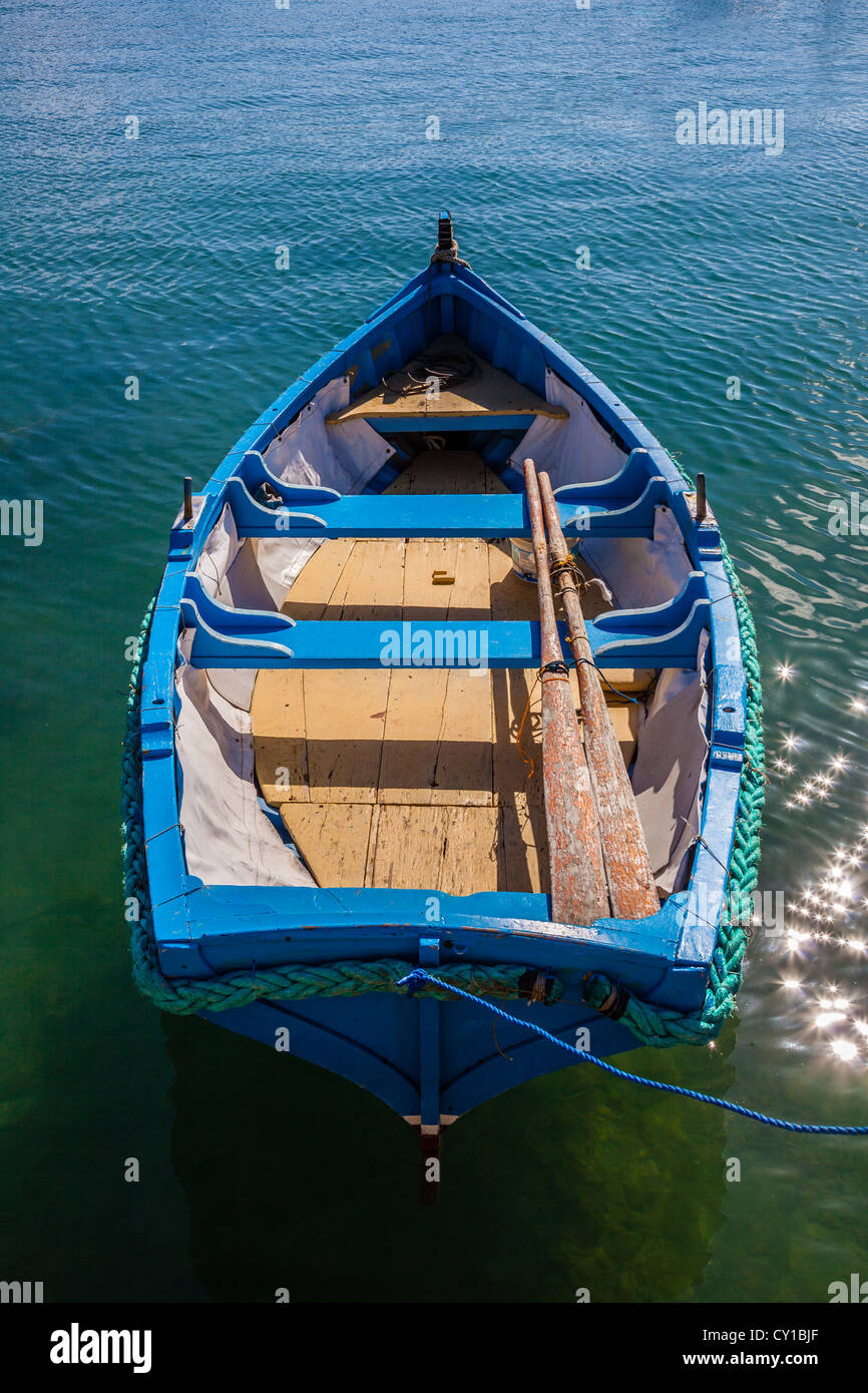Small traditional rowing boat, Marsaxlokk fishing village, Malta Stock Photo
