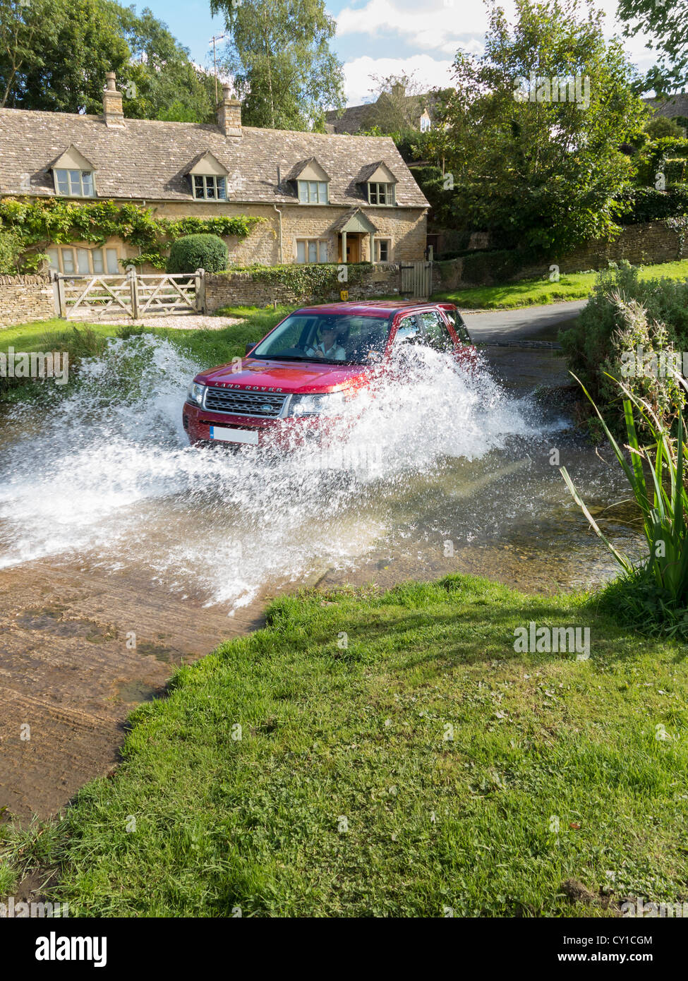 Land rover Freelander crossing a stream, Cotswolds, England Stock Photo