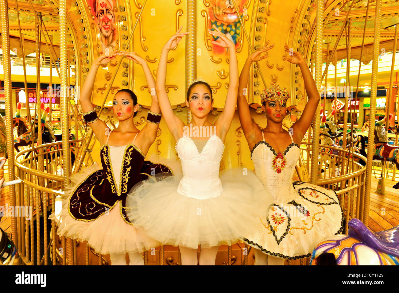 National Ballet of Panama dancers pose as dolls at a merry go round. Stock Photo