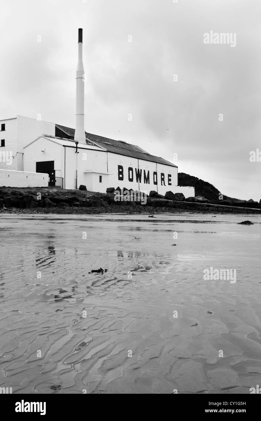 Black and white image of the Bowmore malt whisky distillery as seen from the beach, Islay, Scotland Stock Photo