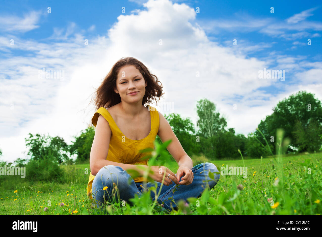 relaxed woman sitting on the grass in the park Stock Photo - Alamy