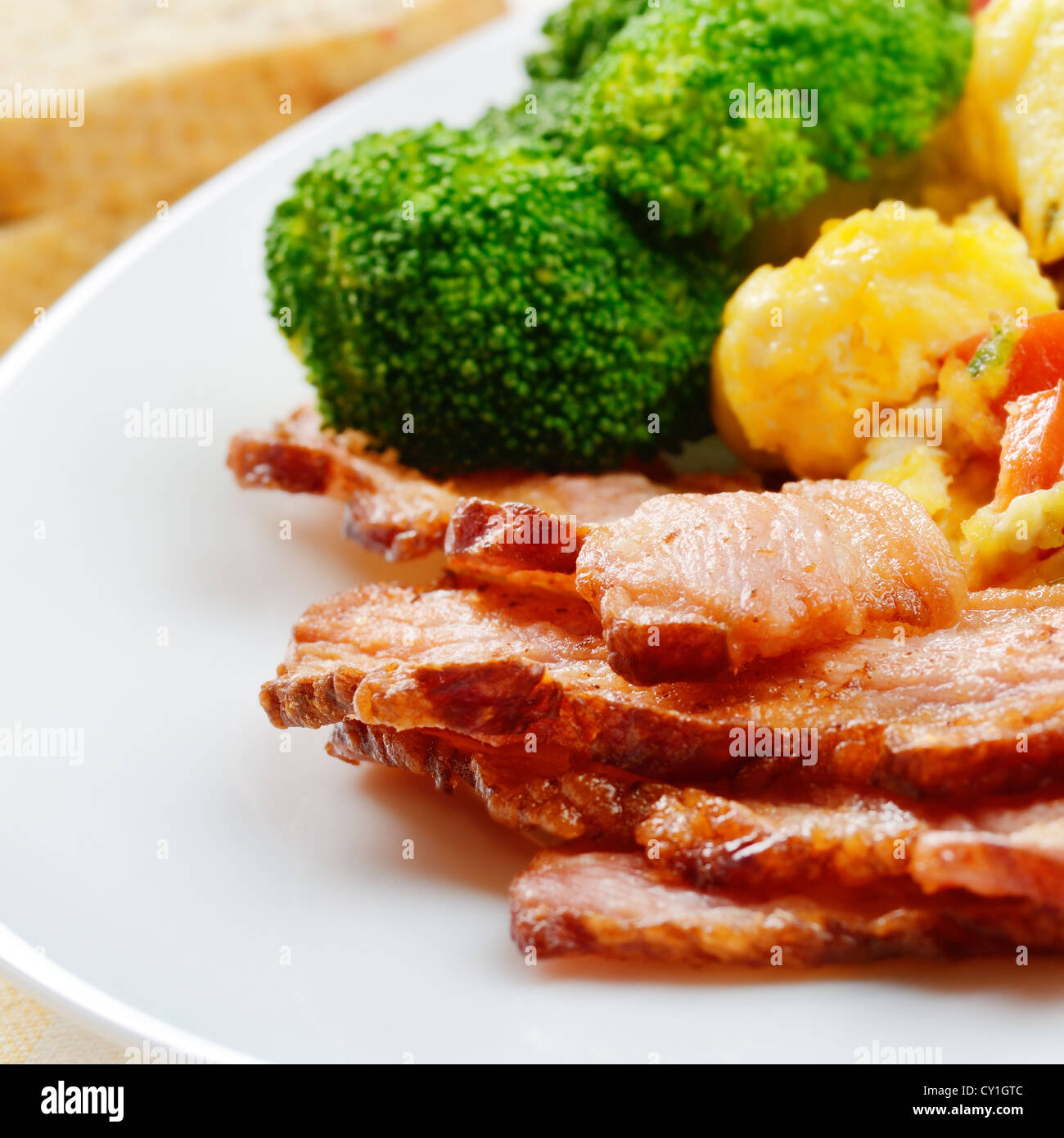 Omelet with vegetables, fried bacon and bread Stock Photo