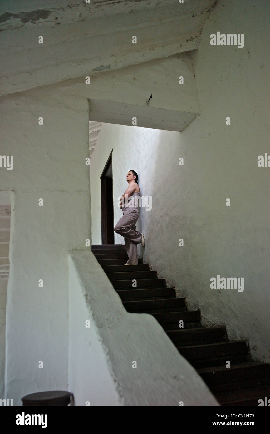 A Colombian dancer poses on the stairwell at the Sugar Cane Museum. Stock Photo