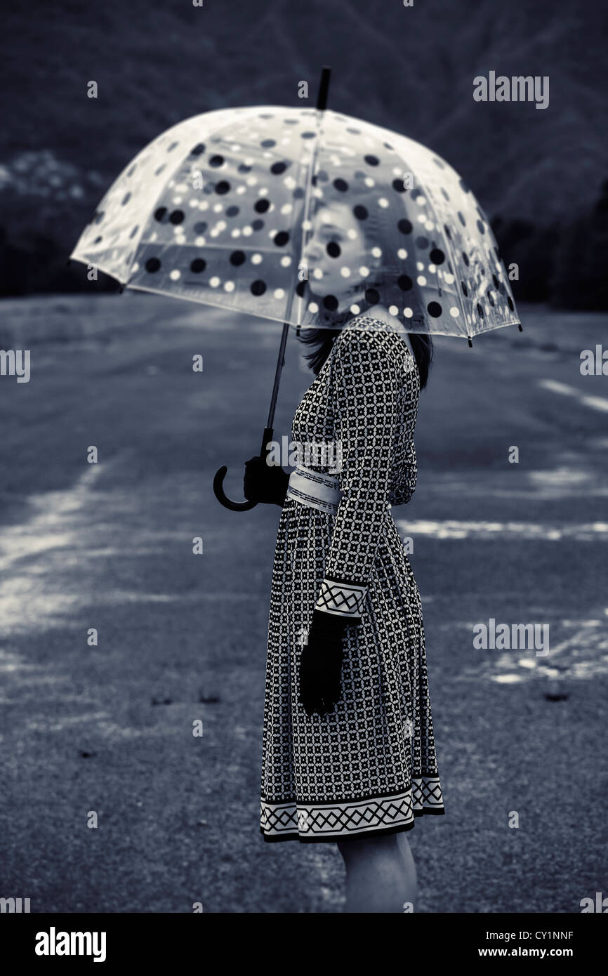 a woman in a black and white dress with a vintage umbrella Stock Photo ...