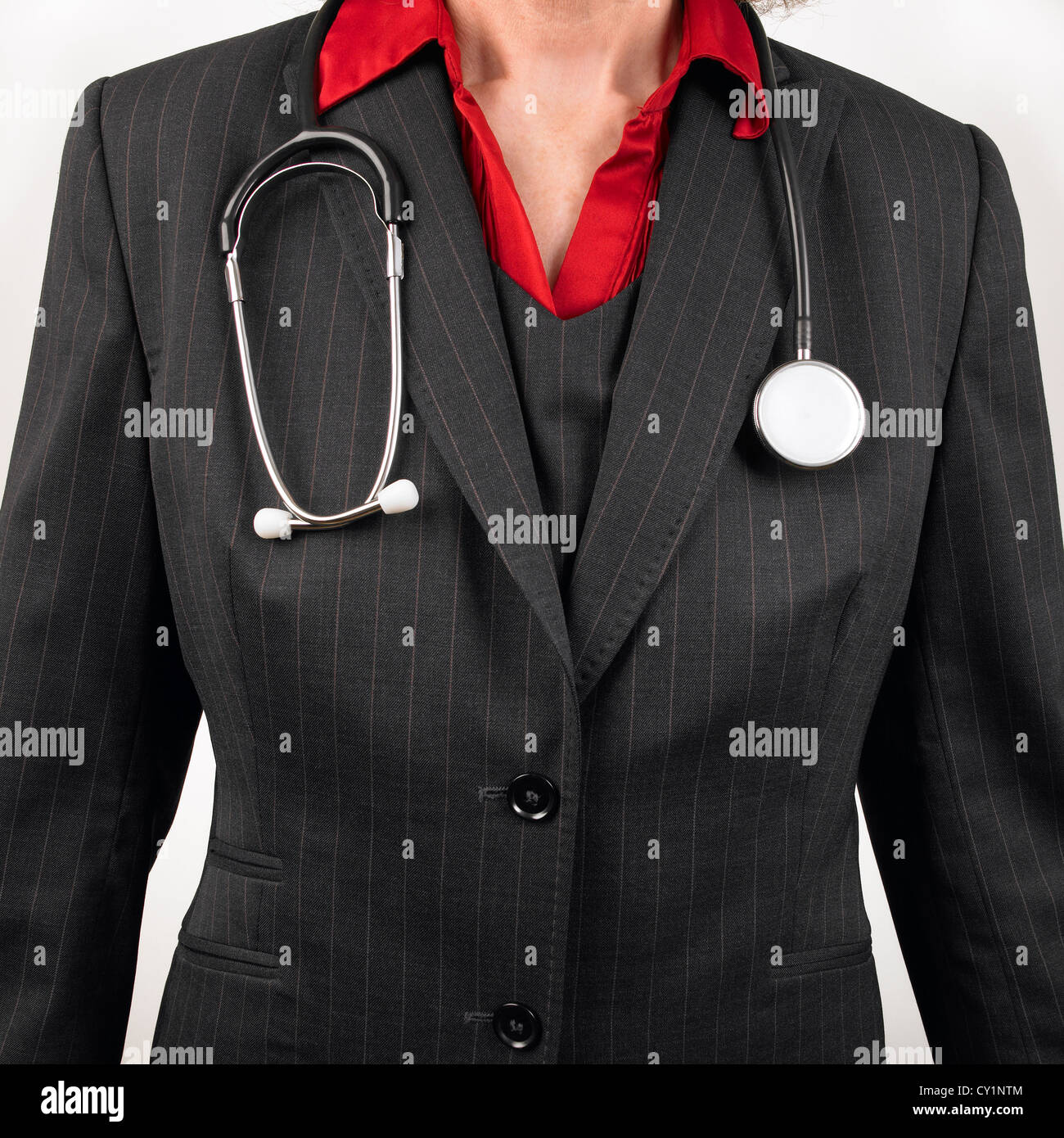 Woman GP wearing pinstripe suit with stethoscope around neck Stock