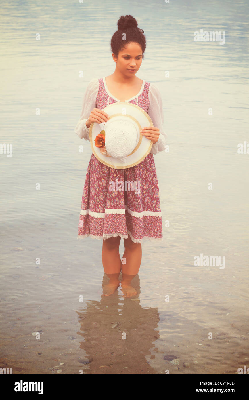 woman with vintage hat and dress standing in water Stock Photo - Alamy