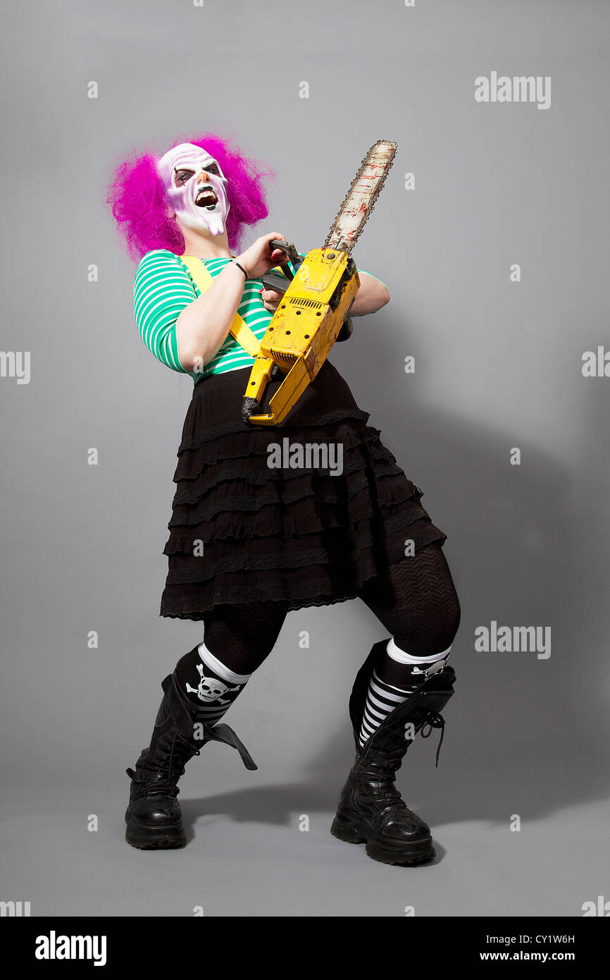 evil clown with chainsaw laughing Stock Photo - Alamy