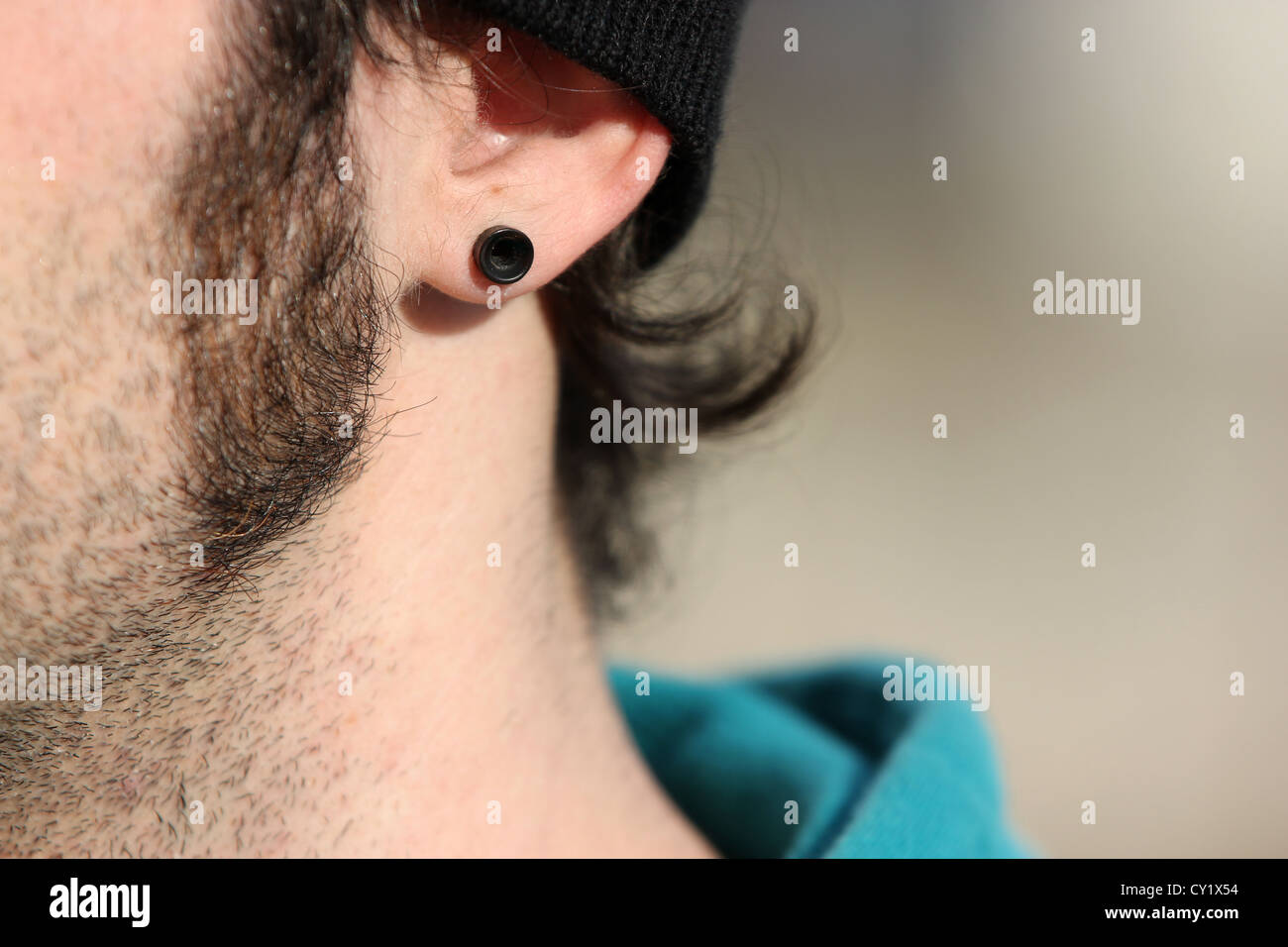 piercing, flash tunnel, sideburns, indy, skateboarder, detail, photoarkive Stock Photo