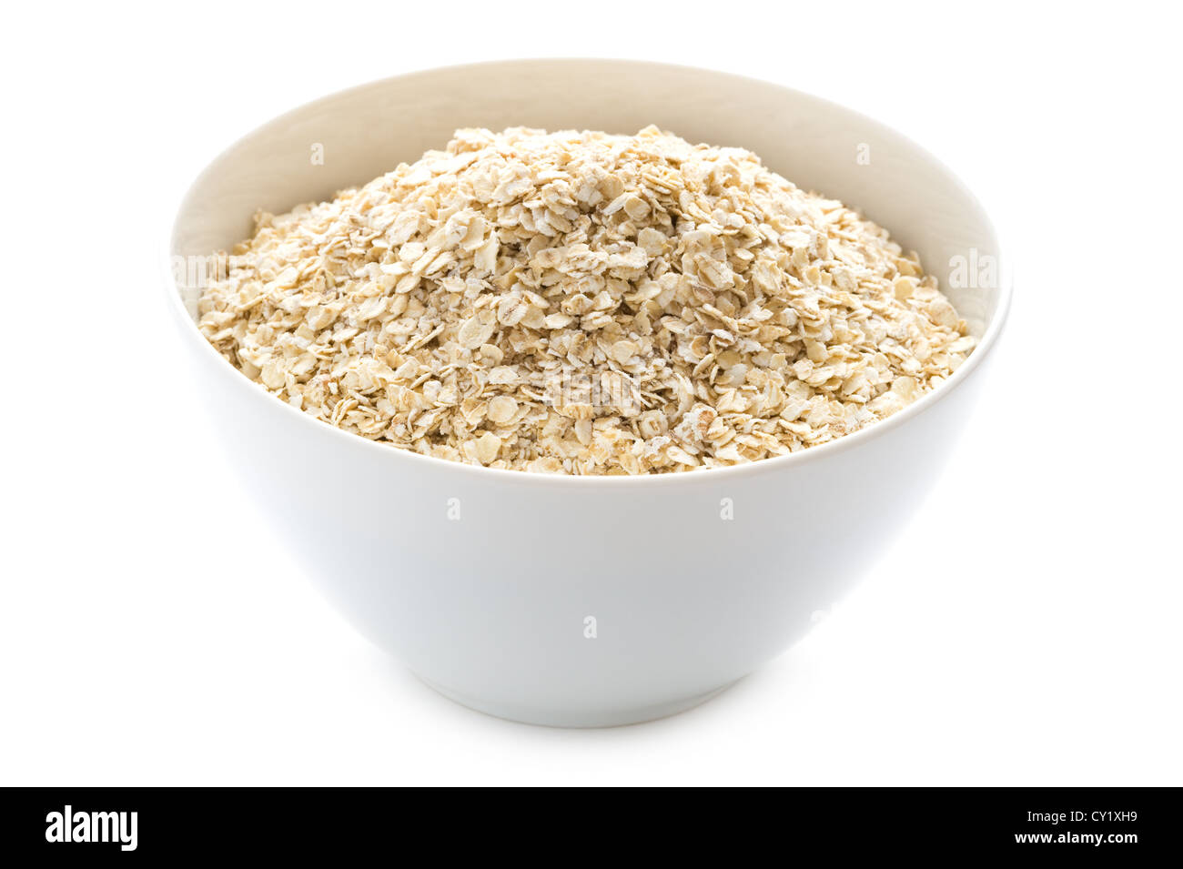 porridge oats dry uncooked in a white bowl isolated on a white background Stock Photo