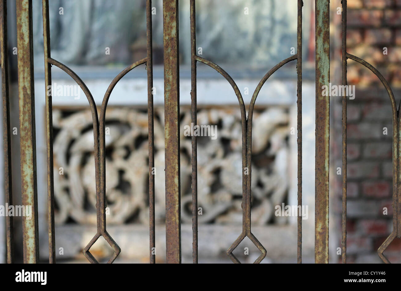 Image of rusty fence with old house in the background Stock Photo - Alamy