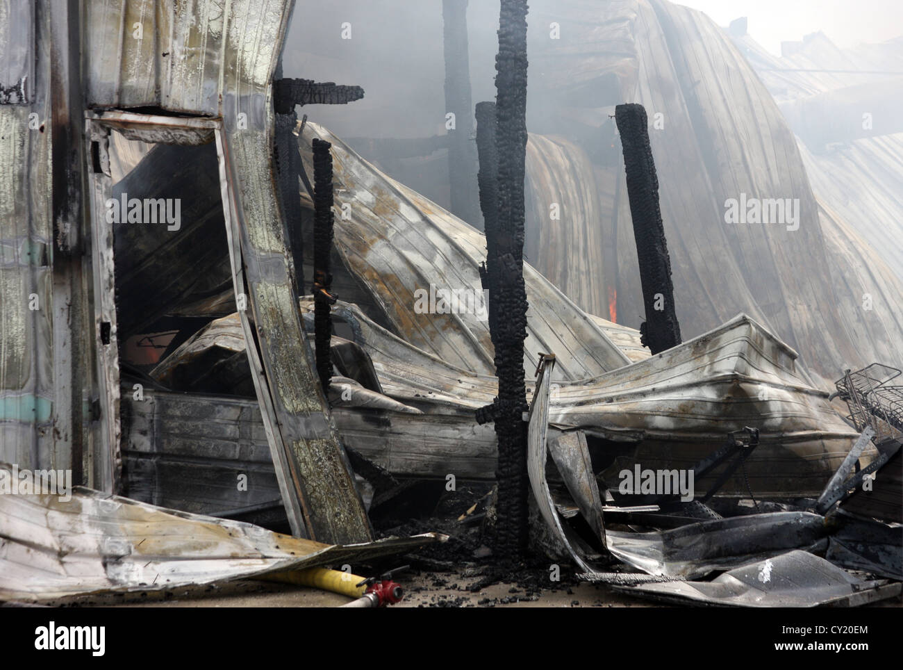 The debris left after a fire in a sheet metal building Stock Photo - Alamy