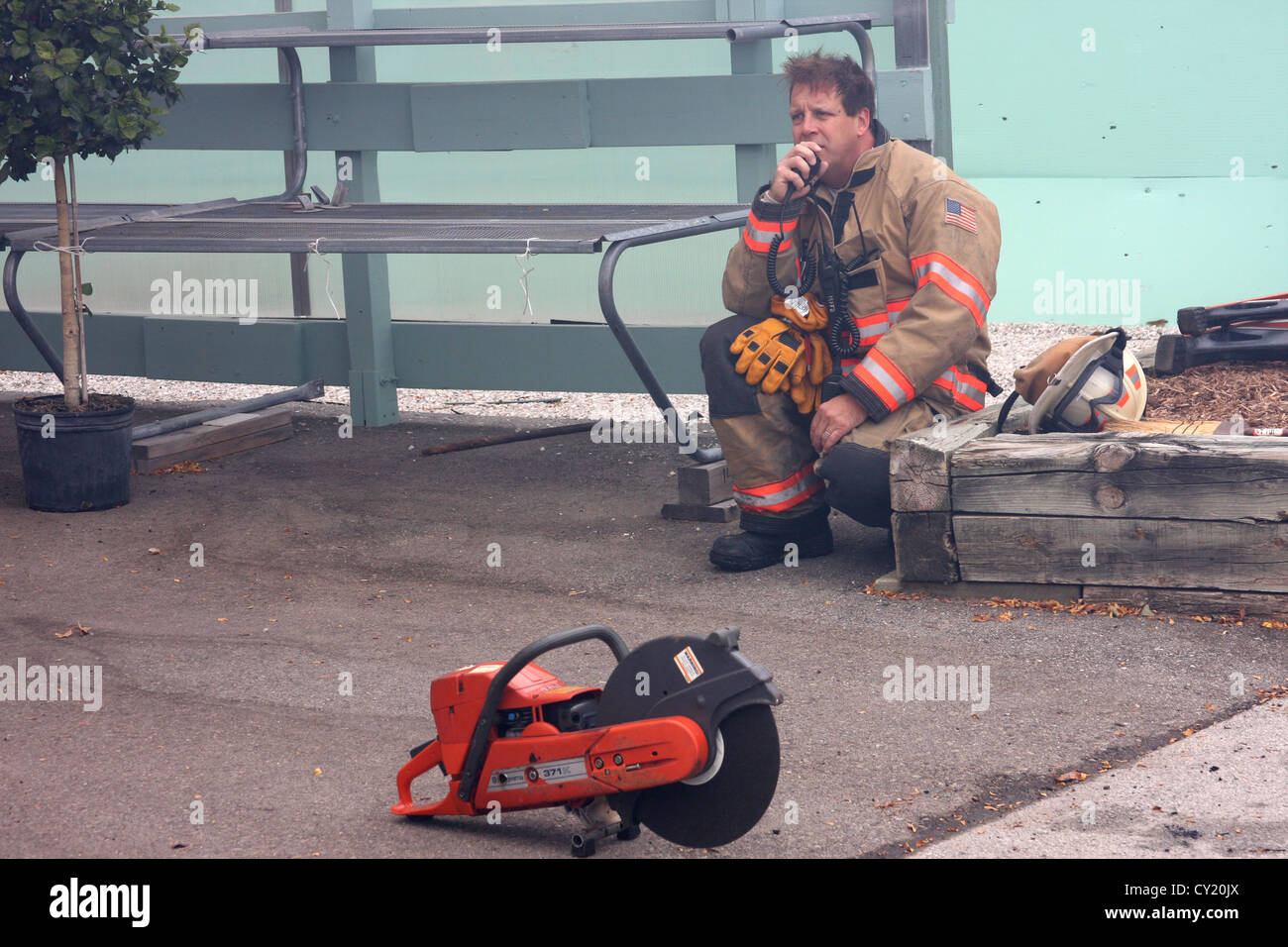 Firefighter on the radio listening to a fire scene chatter Stock Photo Alamy
