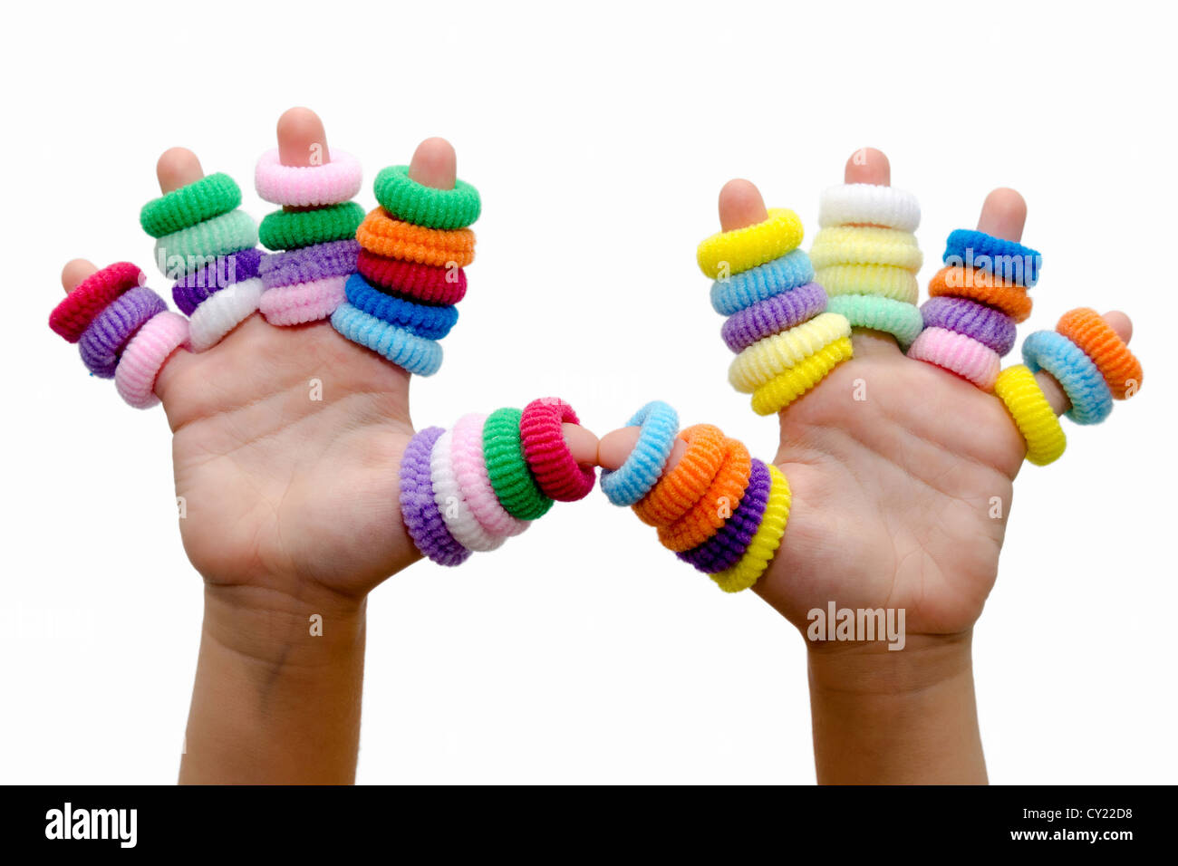 hands of little girl with rubber bands for hair Stock Photo