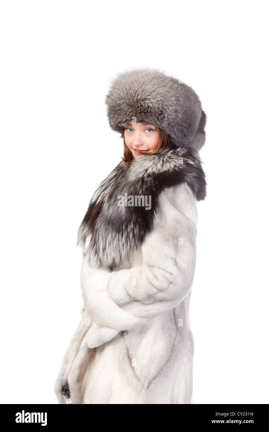 Sexy woman wearing a stylish winter fur coat and hat for protection against  the bitter cold on a white background Stock Photo - Alamy