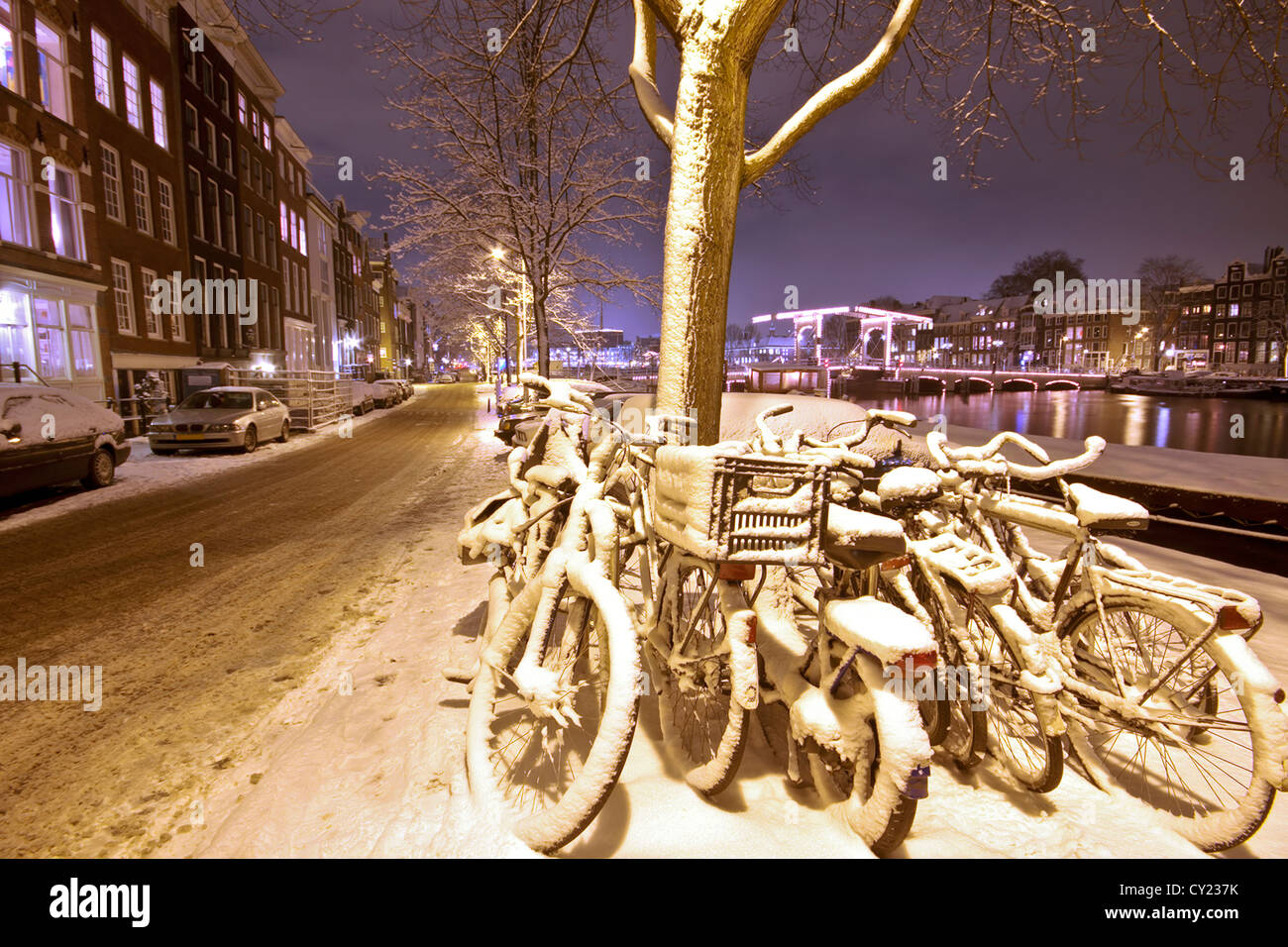 Bikes in the snow in Amsterdam the Netherlands at night Stock Photo Alamy
