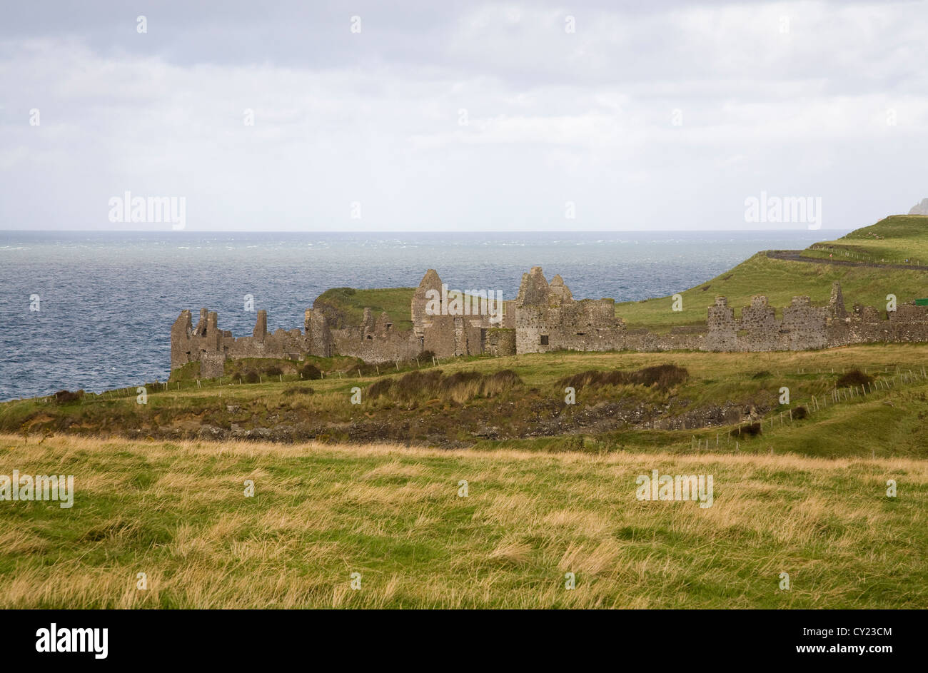Co Antrim Northern Ireland September Ruins of Dunluce Castle on a crag almost surrounded by sea Stock Photo