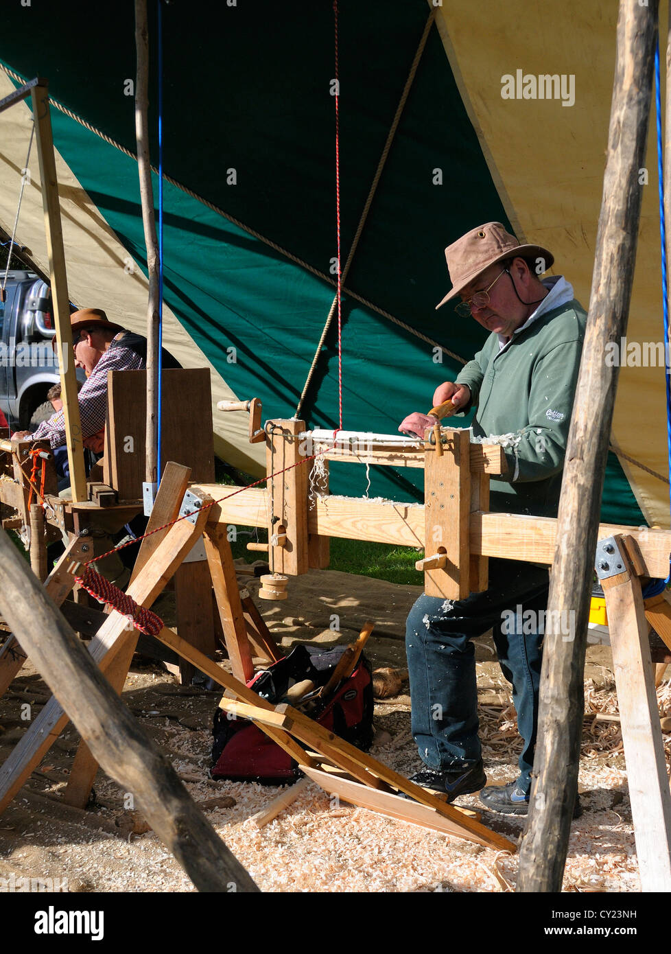 Man demonstrating Pole Lathe Turning , on a treadle lathe,  making chair spindles at the Autumn Countryside Show Stock Photo