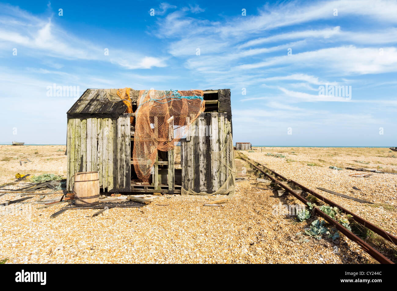 Abandoned building on the shingle beach at Dungeness Kent England UK Stock Photo