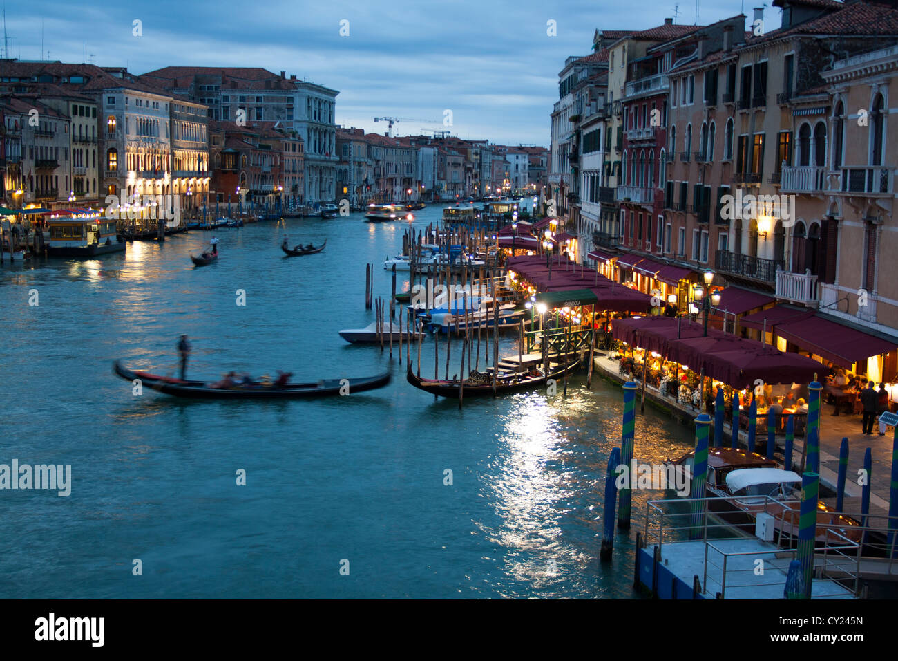 Gondolas on the Grand Canal; view from Rialto Bridge at night , Venice Stock Photo