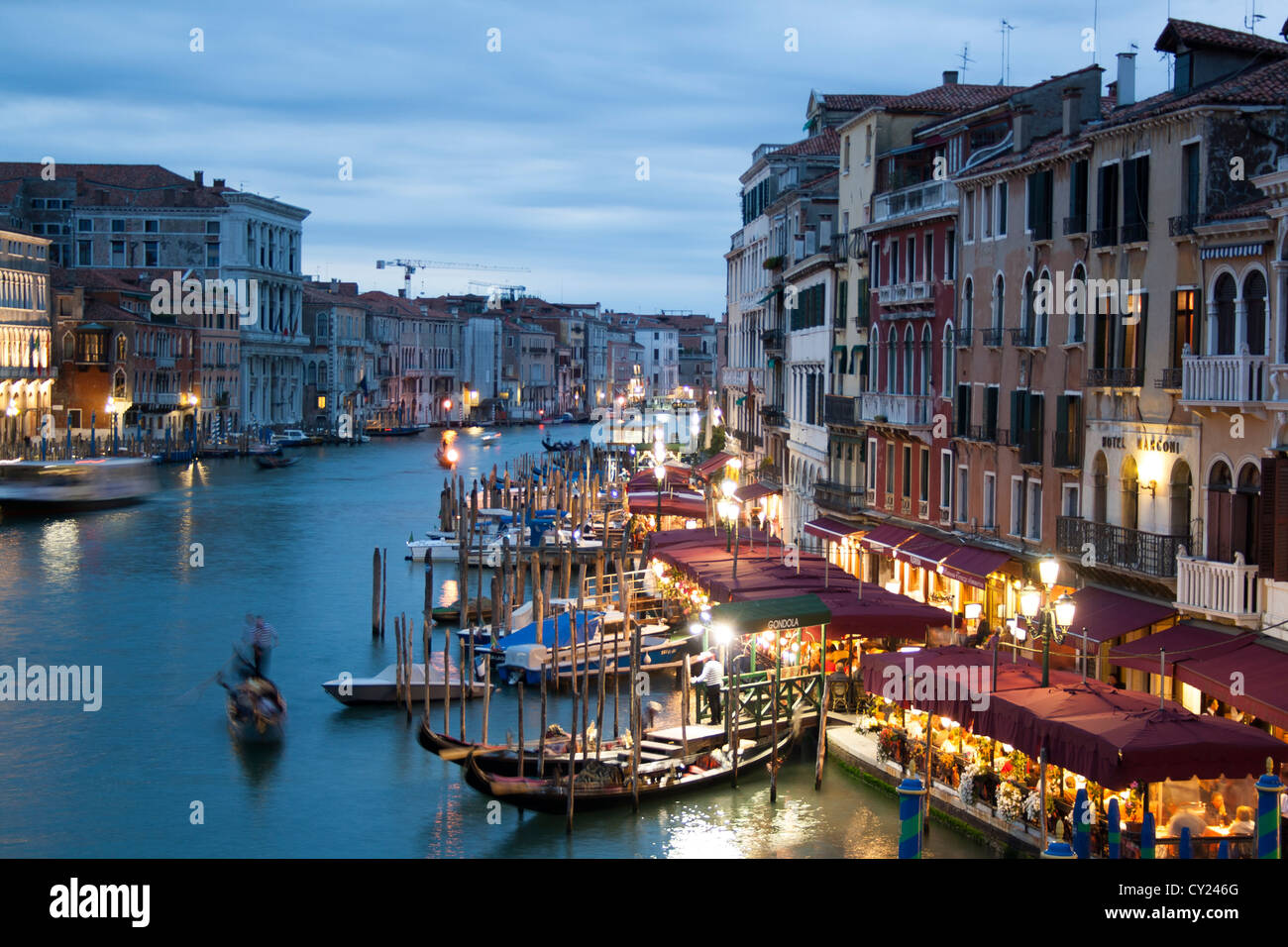 Gondolas on the Grand Canal; view from Rialto Bridge at night , Venice Stock Photo