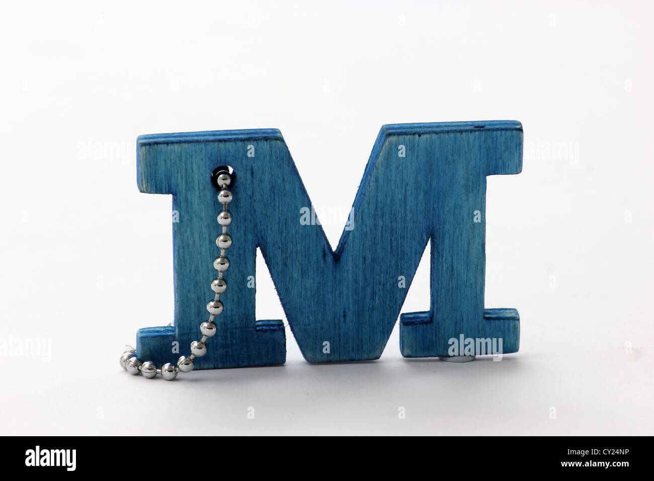 M letter wood key ring on white background studio shot, photoarkive Stock Photo