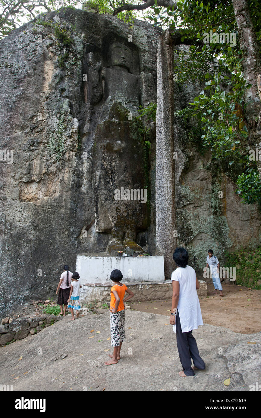 Buddha statue carved into the rock. Dowa temple. Near Ella. Sri Lanka Stock Photo