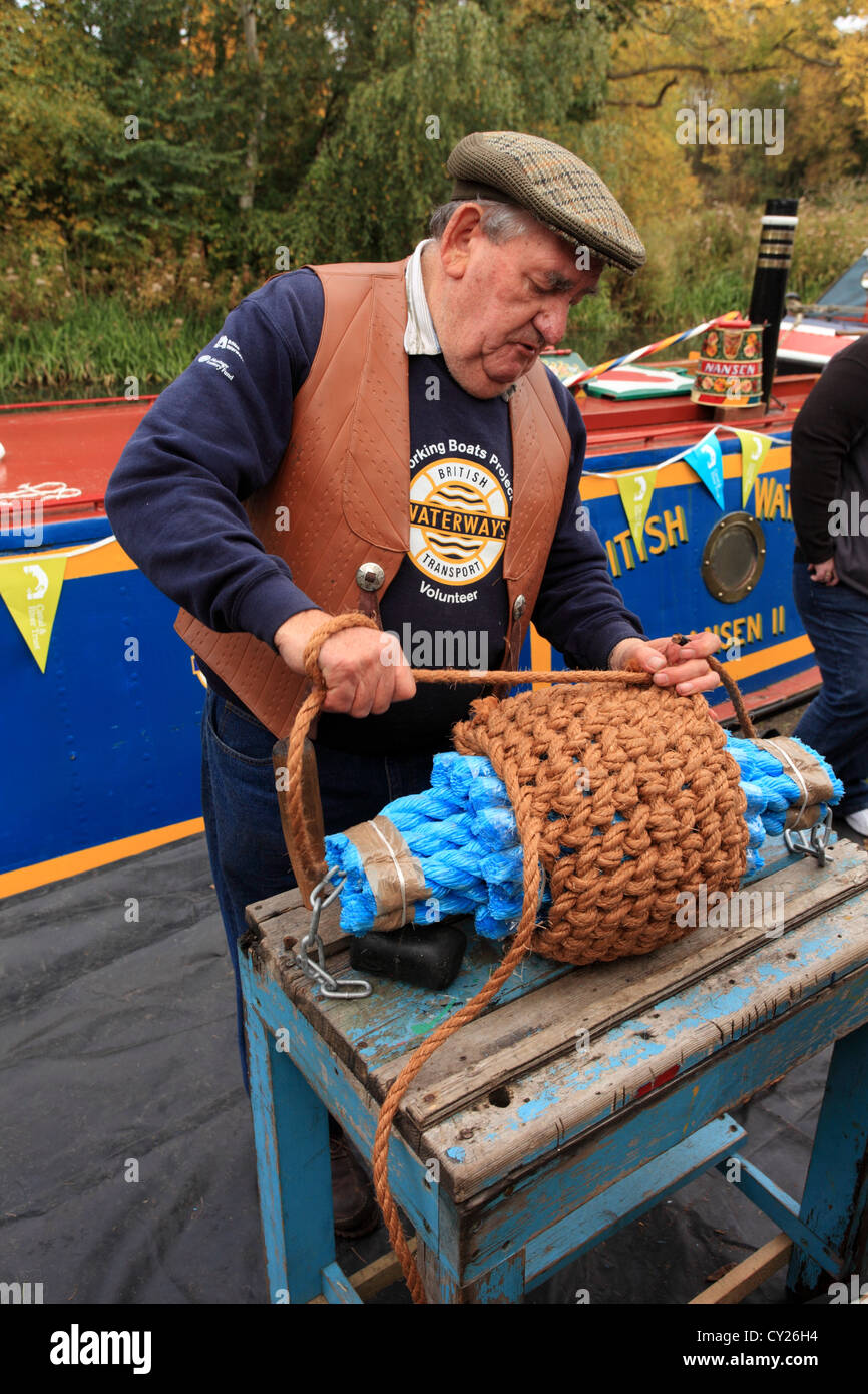 Man making a rope buoy using sisal rope and nylon core for a narrowboat ...