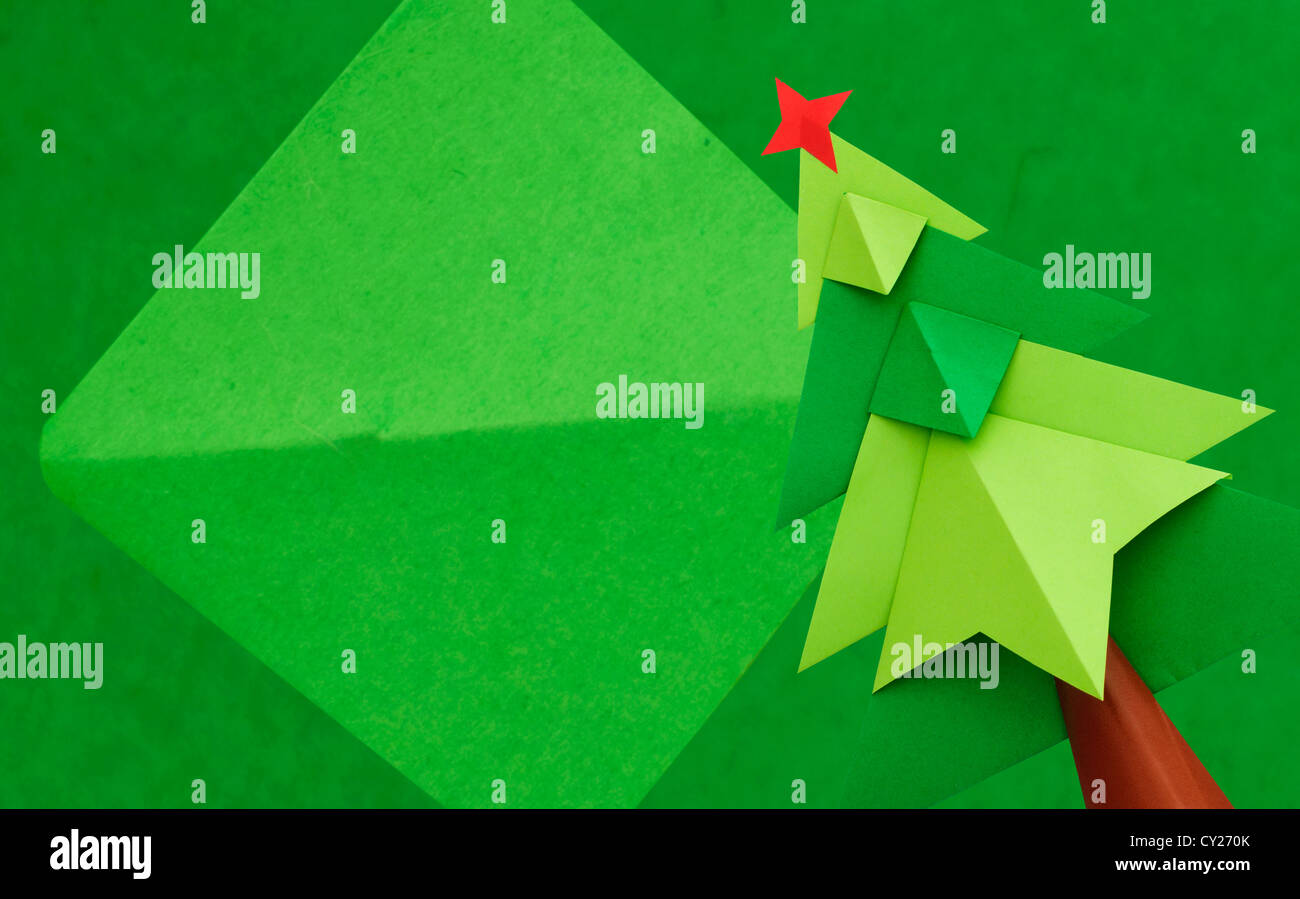 Christmas tree over green paper background. Origami made Stock Photo ...