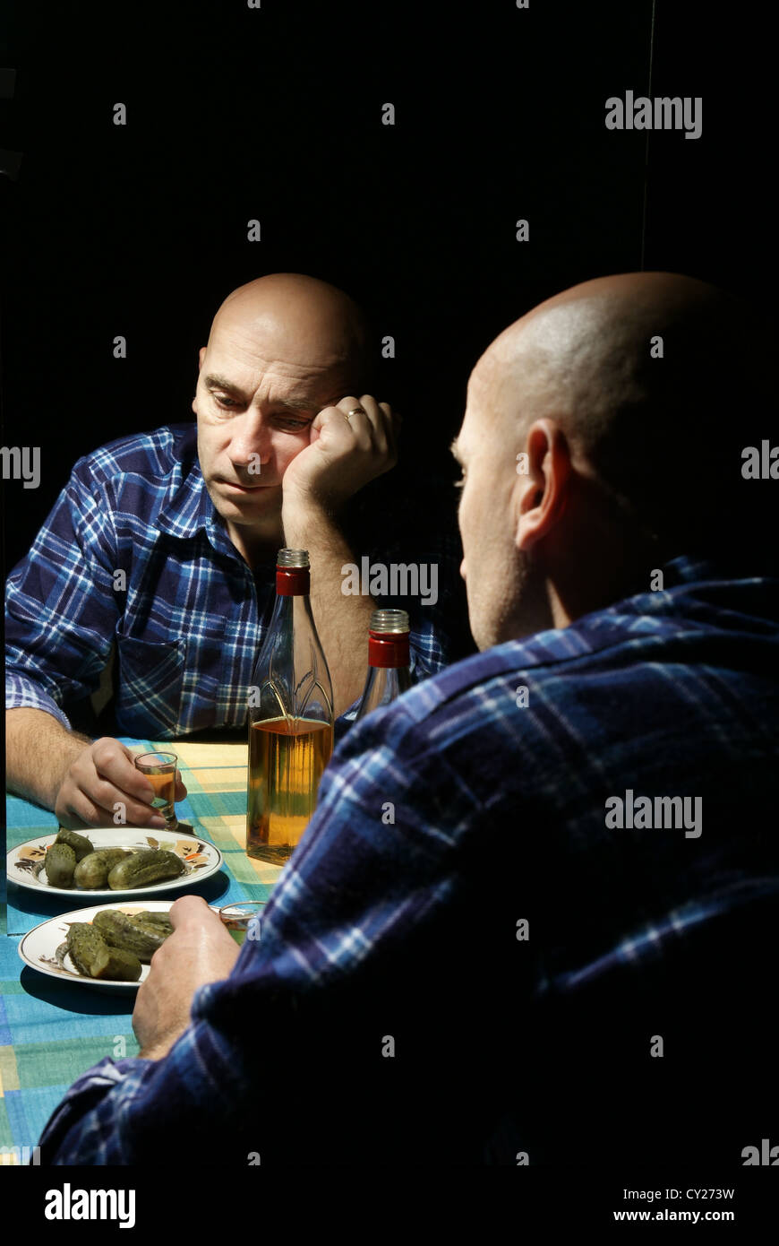 lonely drinking man with reflection in mirror Stock Photo