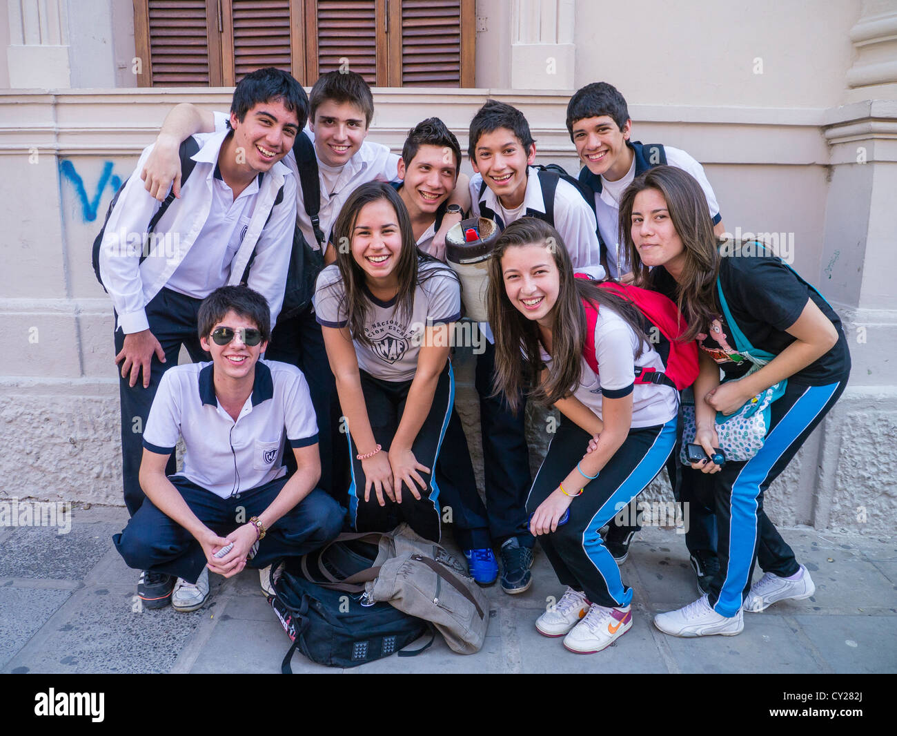 A group of Paraguayan high school students stand outside of their school during lunch break posing for a photograph. Stock Photo