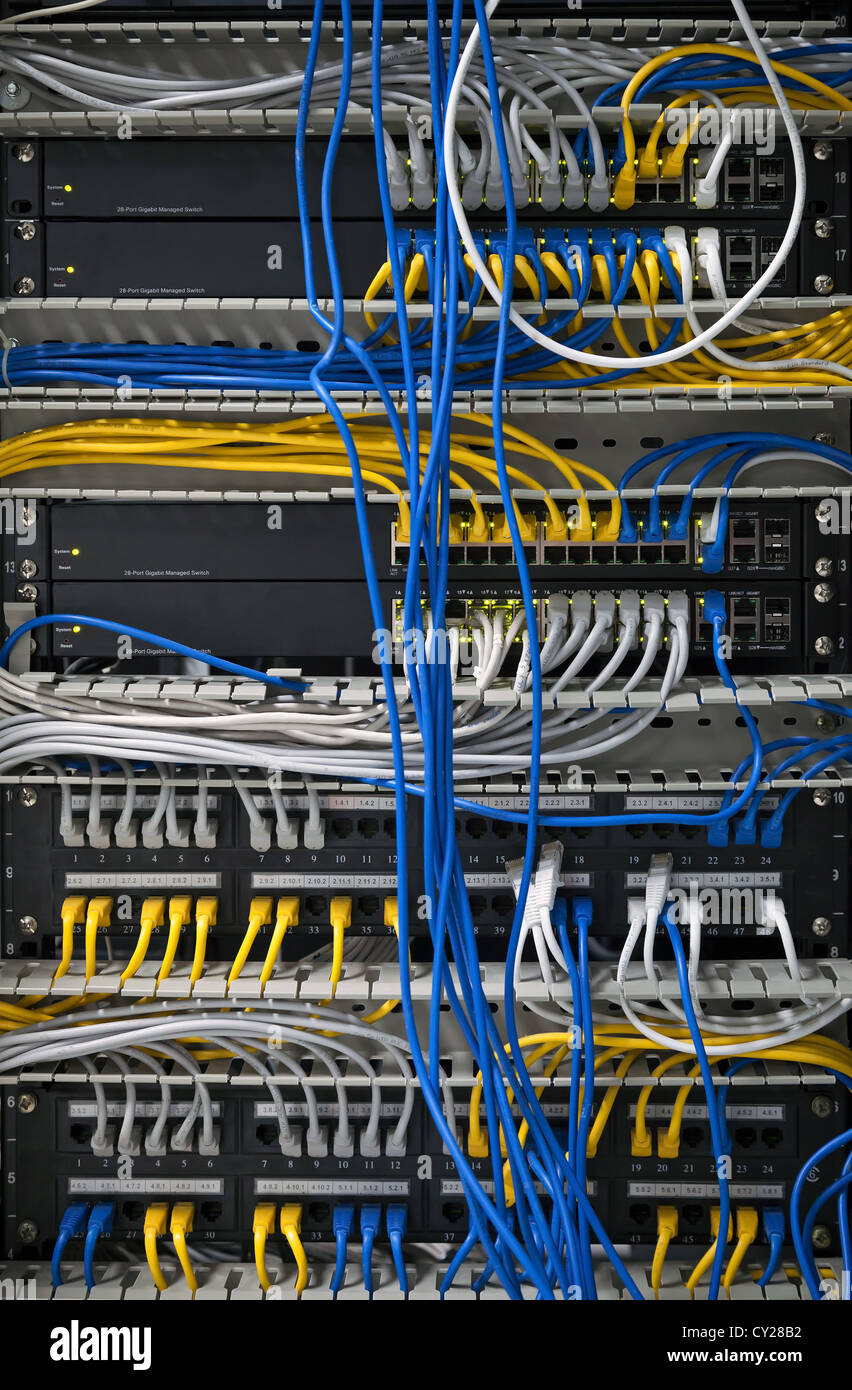 Large network hubs with connected cables Stock Photo