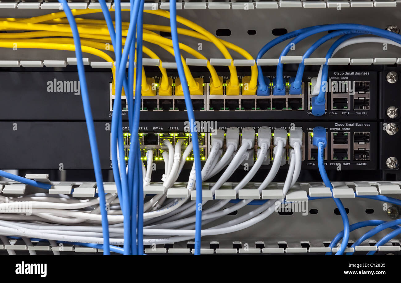 Large network hub panel with connected cables Stock Photo