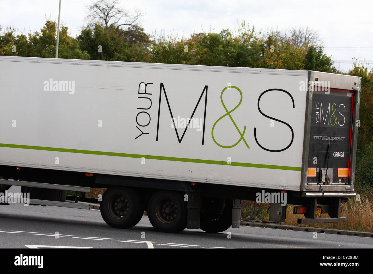 Part of an 'M&S' truck traveling along a road in England Stock Photo