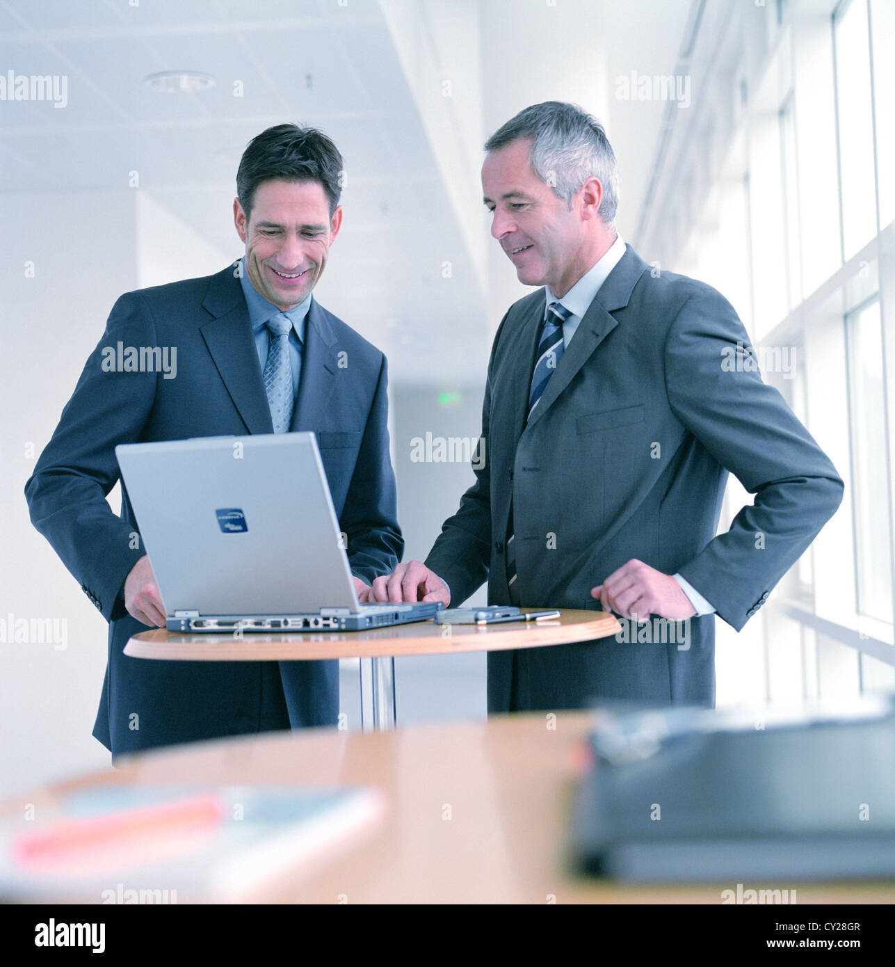 business relationship using laptop notebook kindly partners partnership License free except ads and outdoor billboards Stock Photo