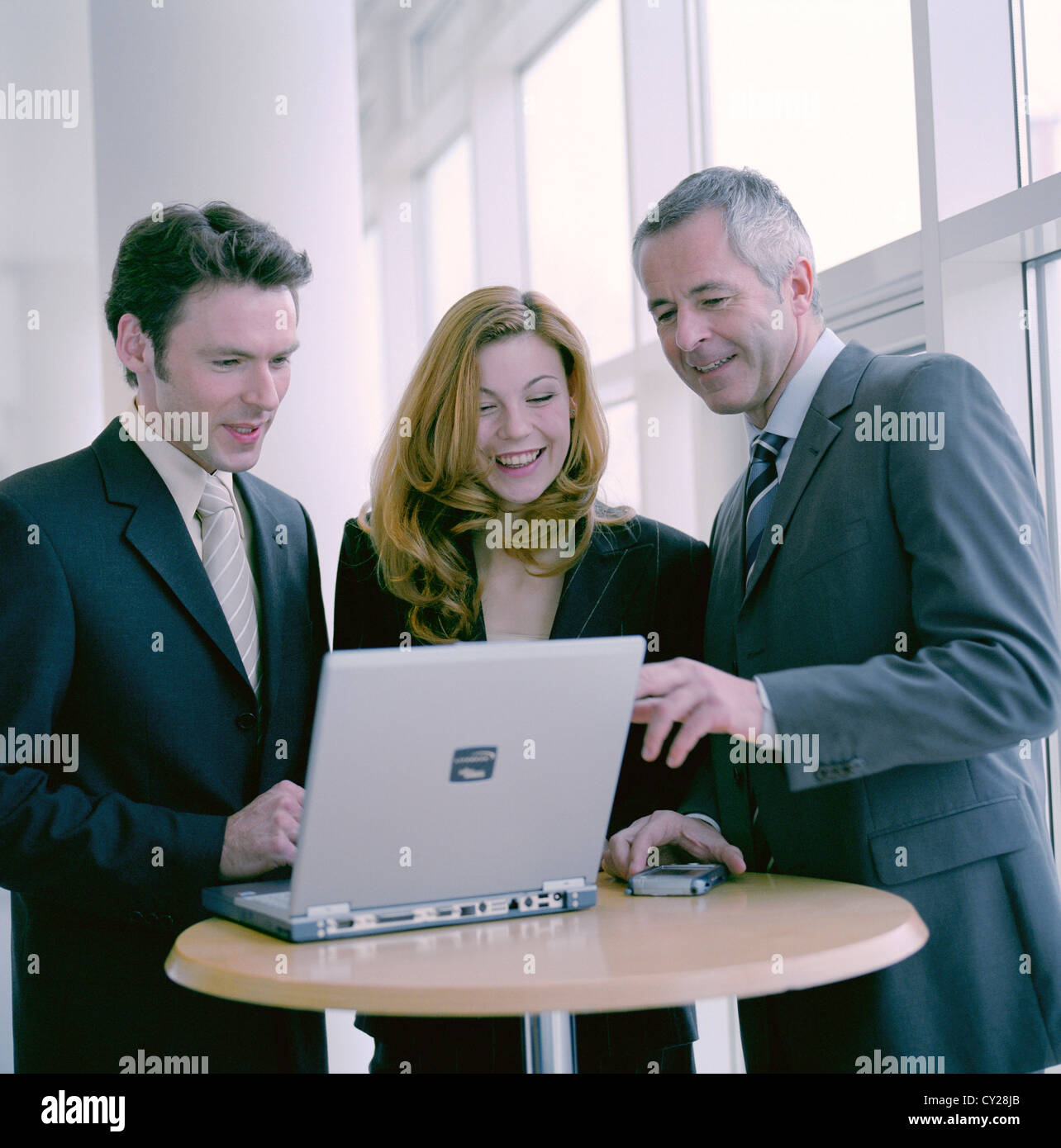 business people man woman confidence cooperation laptop notebook License free except ads and outdoor billboards Stock Photo