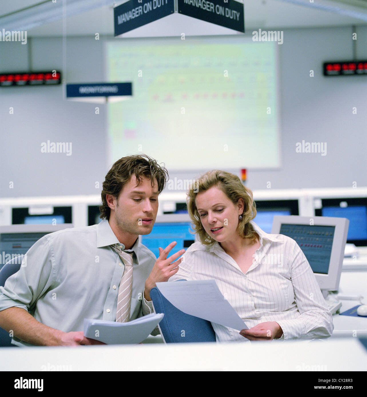 business people data center control center man woman world clock License free except ads and outdoor billboards Stock Photo