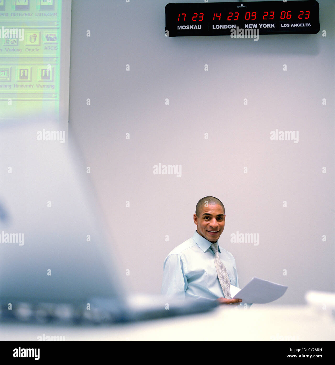 business people data center control center man desk world clock License free except ads and outdoor billboards Stock Photo