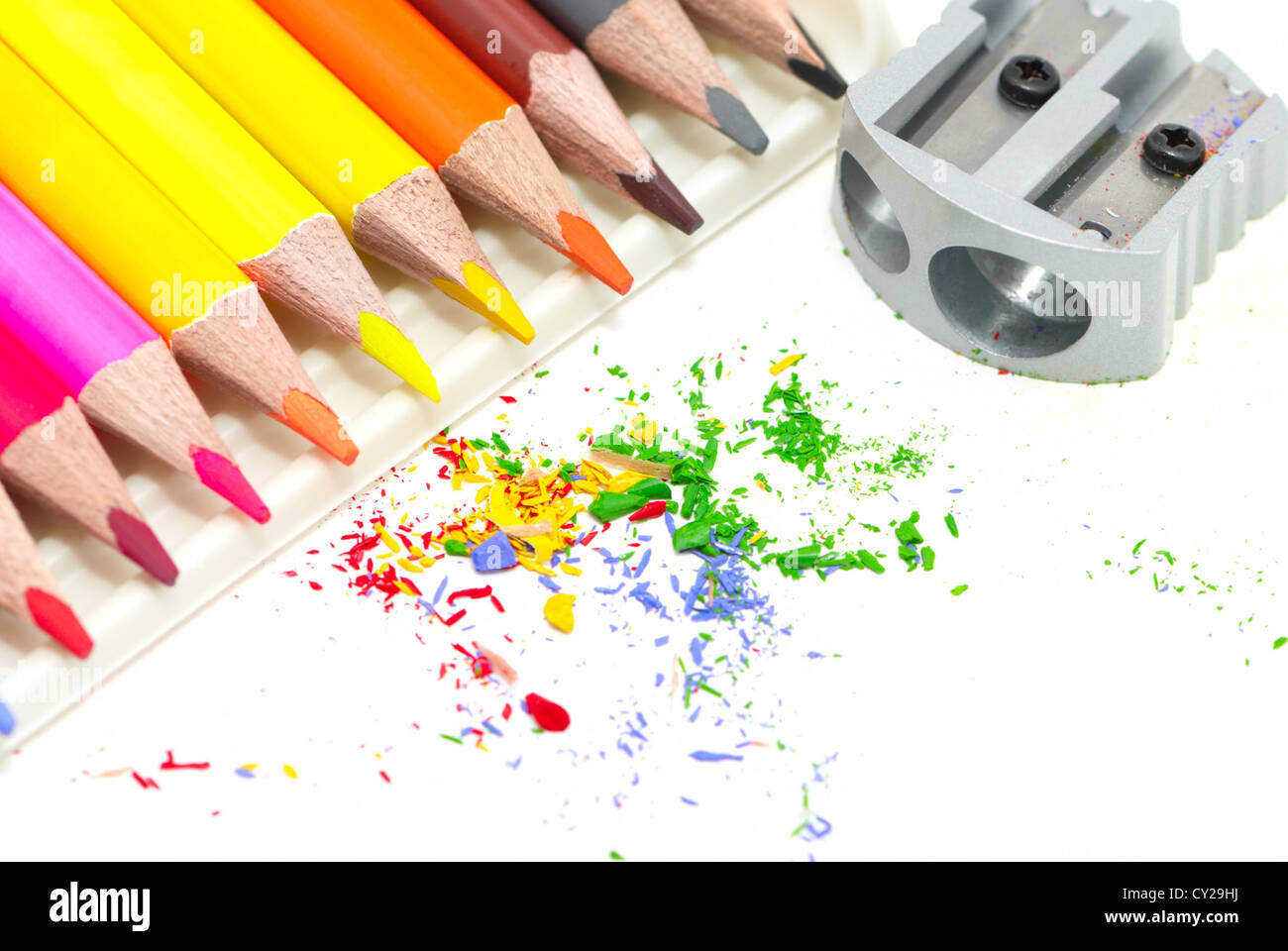 Pencils with a sharpener and shaving on a white background Stock Photo