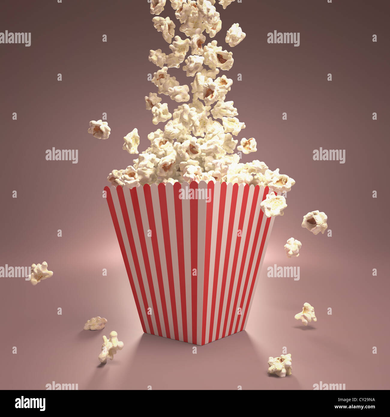Dropping popcorn in striped classic package. Stock Photo