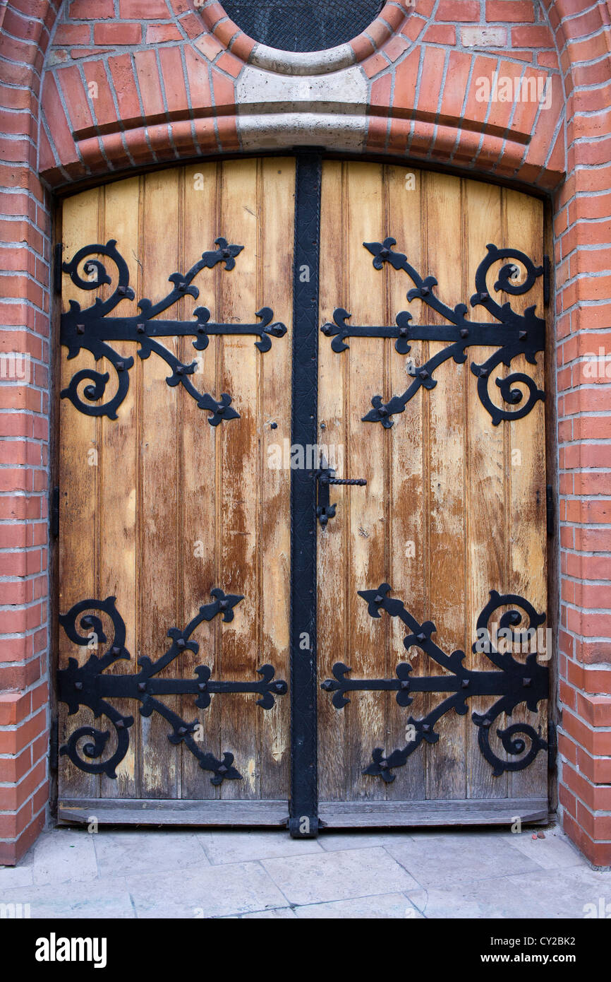 An old antique wooden door with wrought iron ornate reinforcement in ... An old antique wooden door with wrought iron ornate reinforcement in ...