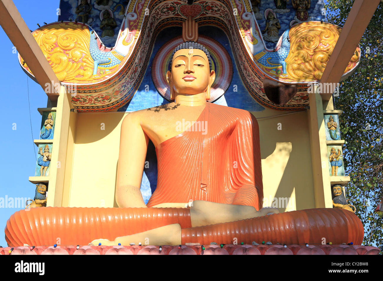 Buddhist statue in roadside temple near Pinnawala. Stock Photo