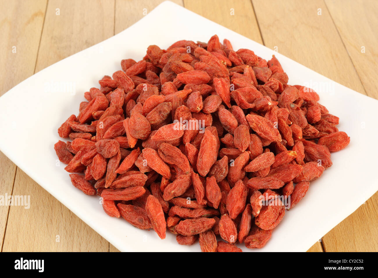 bunch of goji berries on a white plate Stock Photo