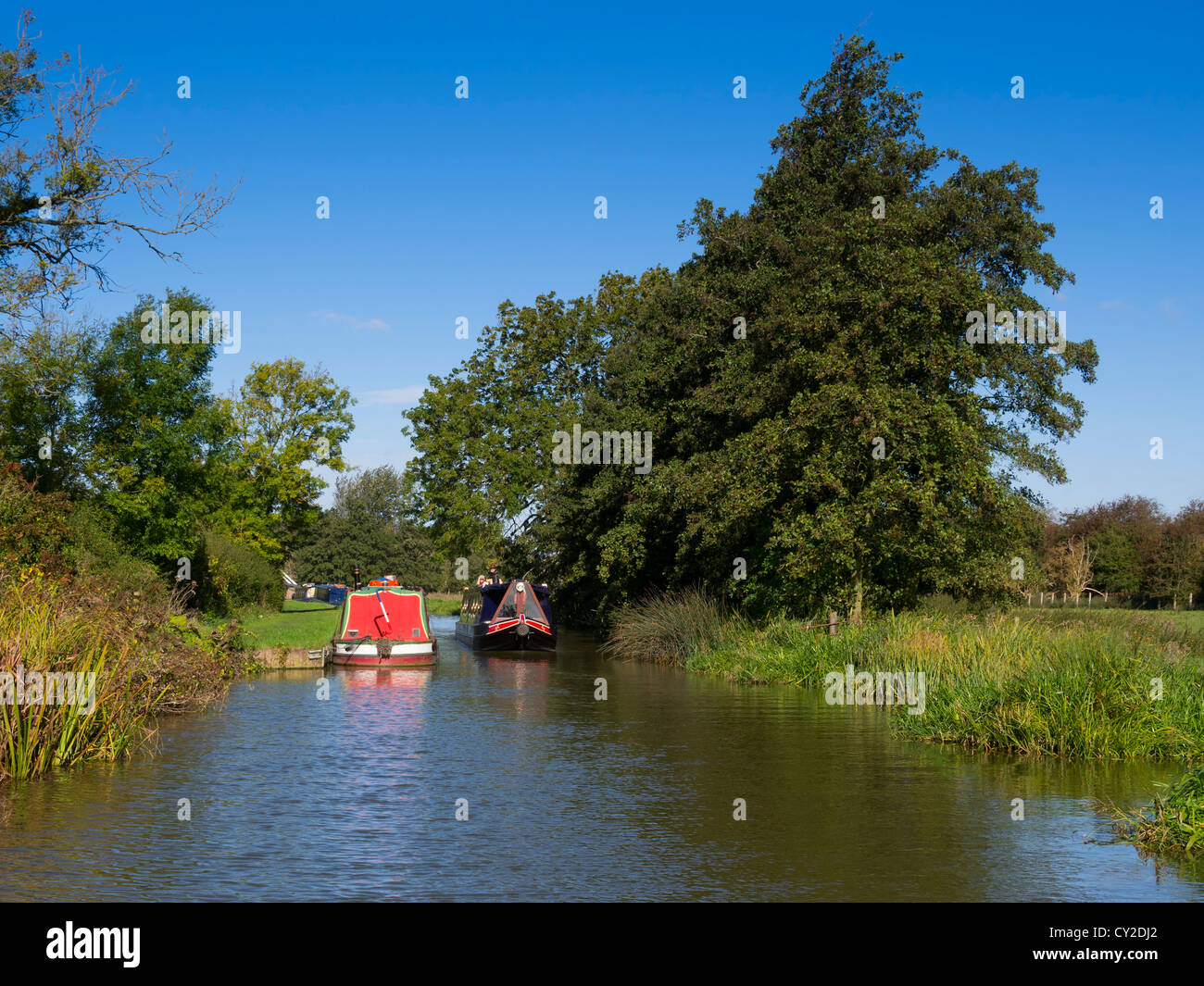 Narrowboats passing on the Oxford Union Canal near Heyford Wharf, Oxfordshire Stock Photo